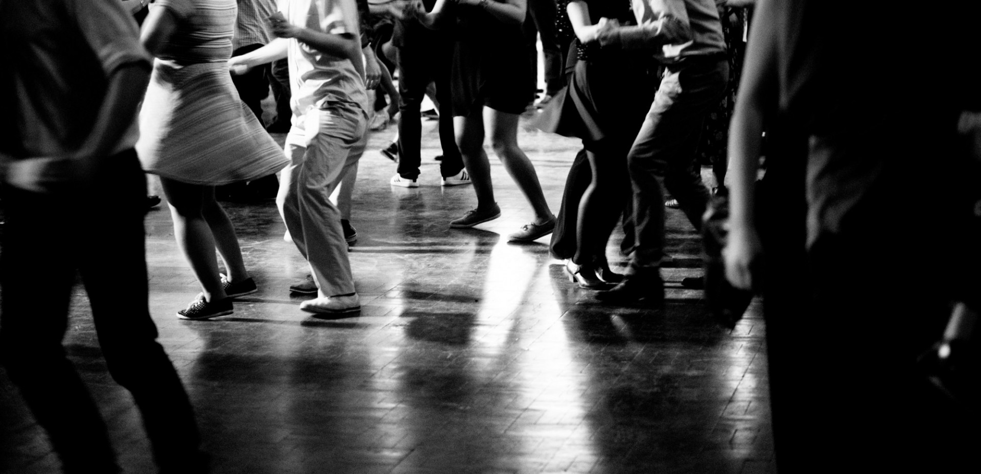 black and white image of people dancing on a dancefloor