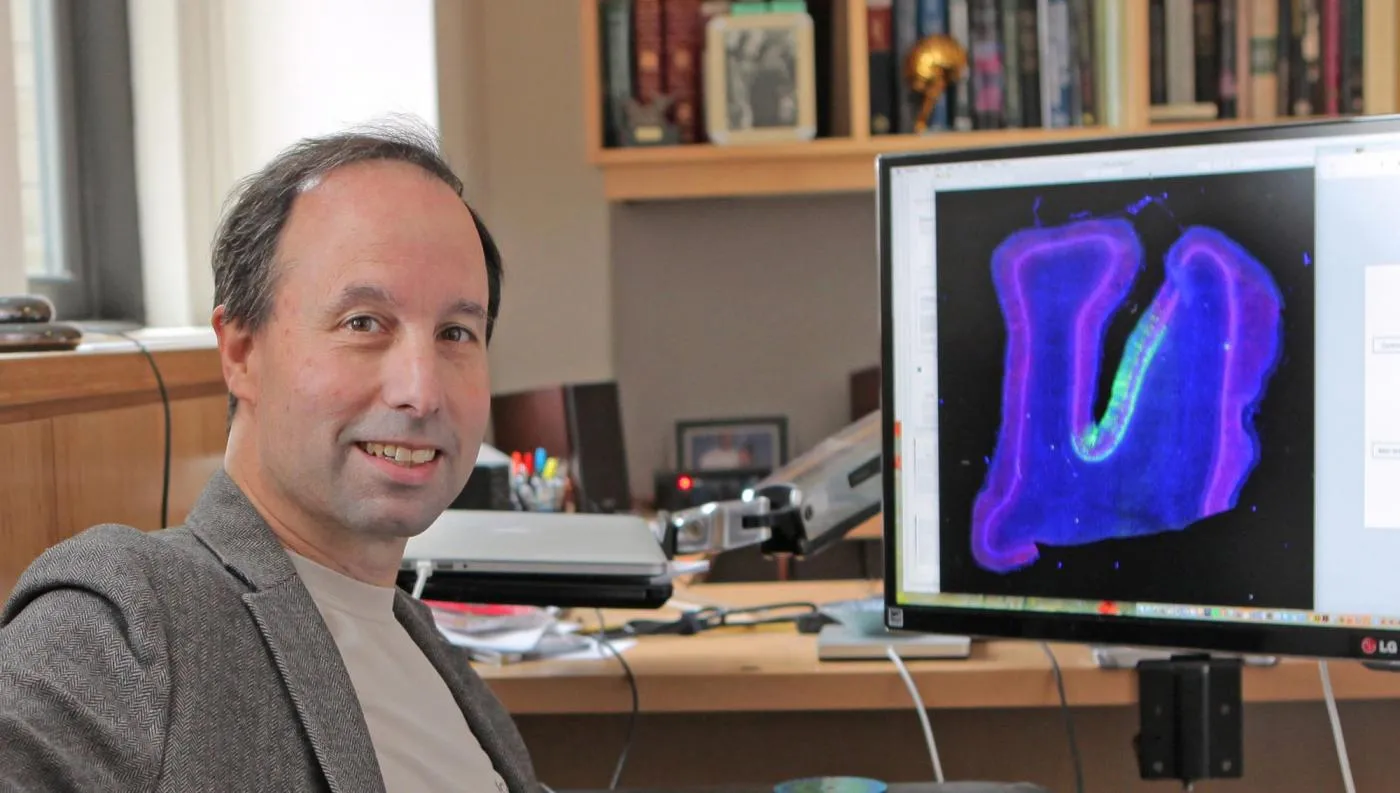 Michael Shadlen sitting at his desk